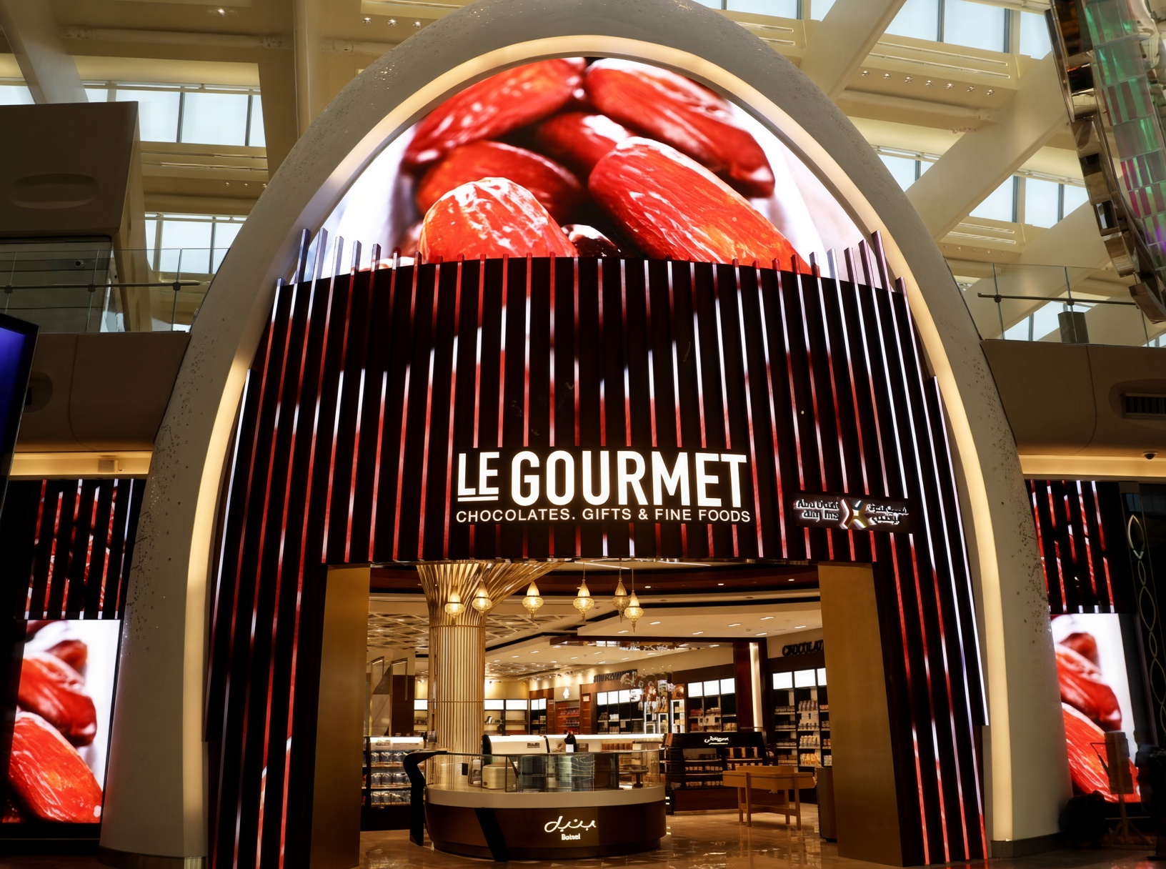 Curved digital display and side screens at Abu Dhabi Airport